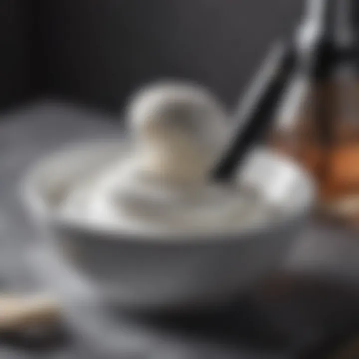 A close-up of a luxurious shaving cream in a bowl with a brush beside it.