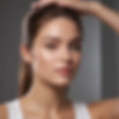 An individual applying DPHue ACV Dry Shampoo into their hair, demonstrating the application technique.