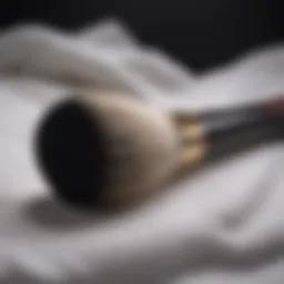 A clean makeup brush resting on a white towel