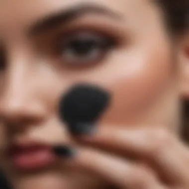 Nail technician applying black dip powder expertly