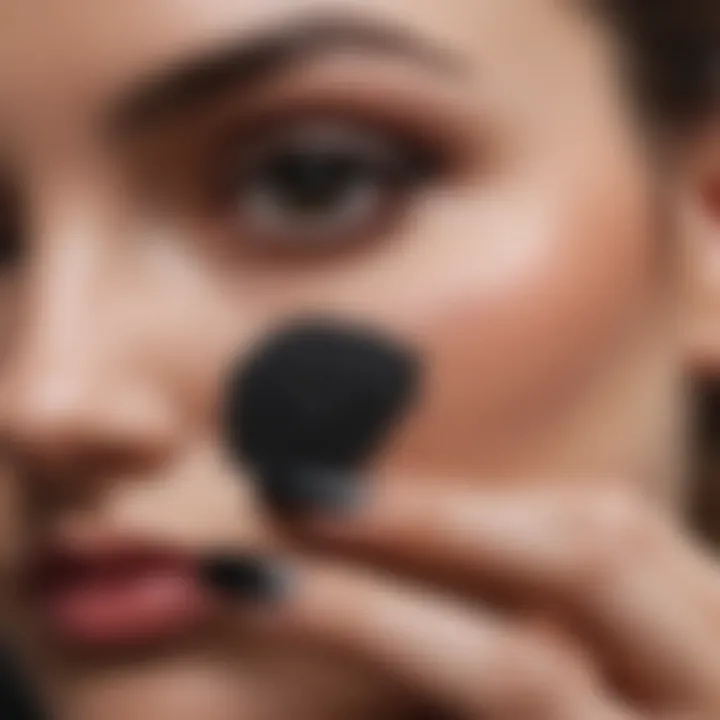 Nail technician applying black dip powder expertly