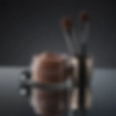 Elegant makeup brush beside an open eyebrow pomade jar