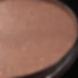 A close-up of a shimmering highlighter product reflecting light.