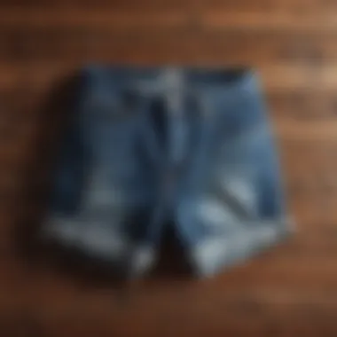 Stylishly folded jean shorts on a wooden surface