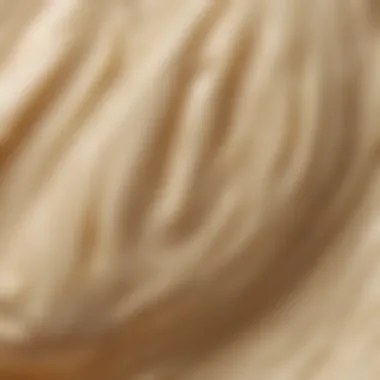 Close-up view of the creamy texture of shea butter on a smooth surface.